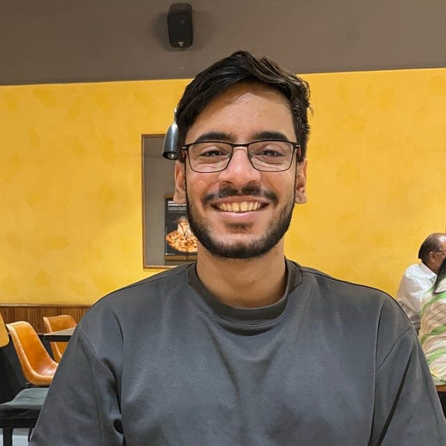Yogeshwar Chaturvedi, founder of GuestDrop, smiling in a grey sweatshirt
